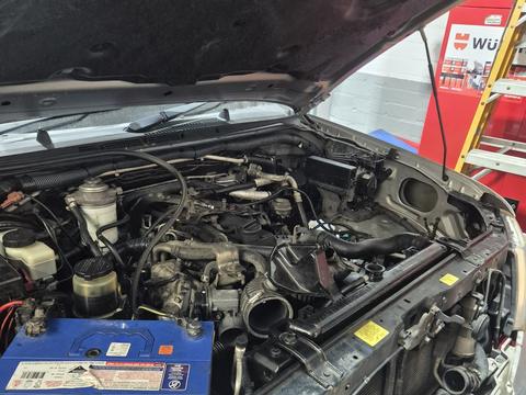 Engine bay of a car opened up for servicing at the Surry Hills workshop